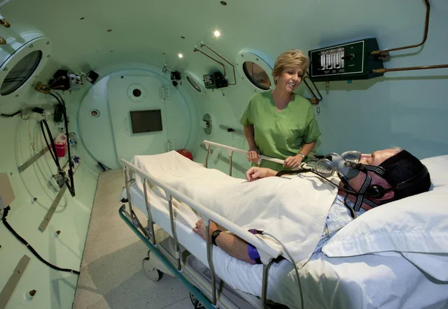 Nurse monitoring patient during HBOT session